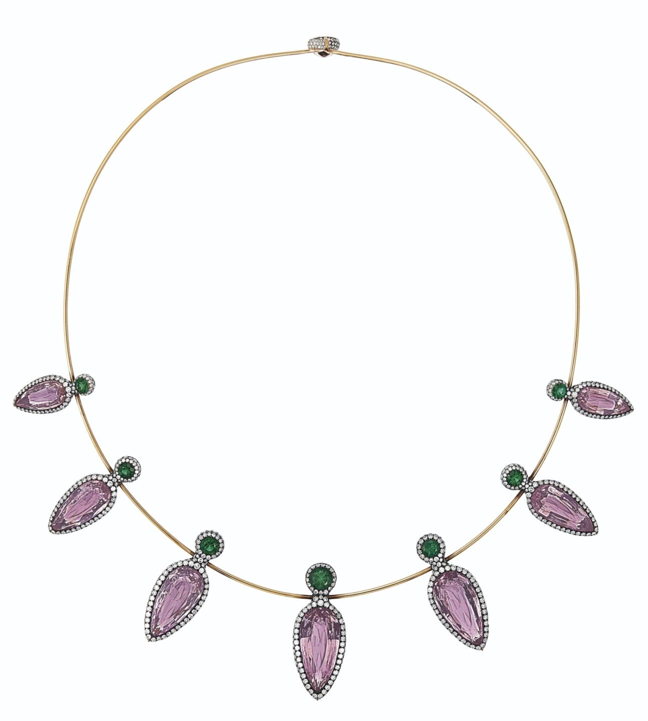 Elegant gold necklace with purple teardrop gems and green accents against a plain background