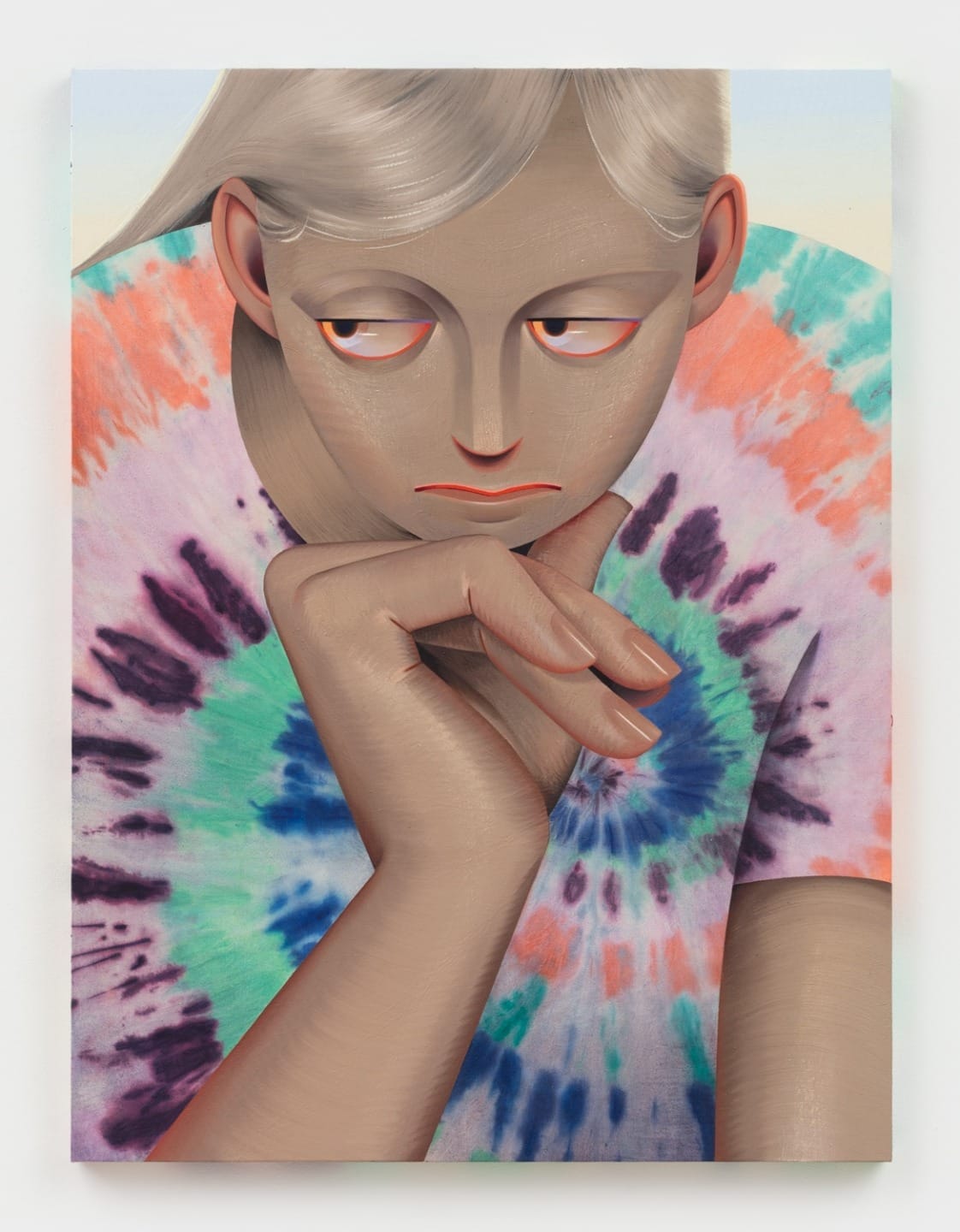 Portrait of a person with light hair, wearing a colorful tie-dye shirt, resting their chin on their hand, with a pondering expression.