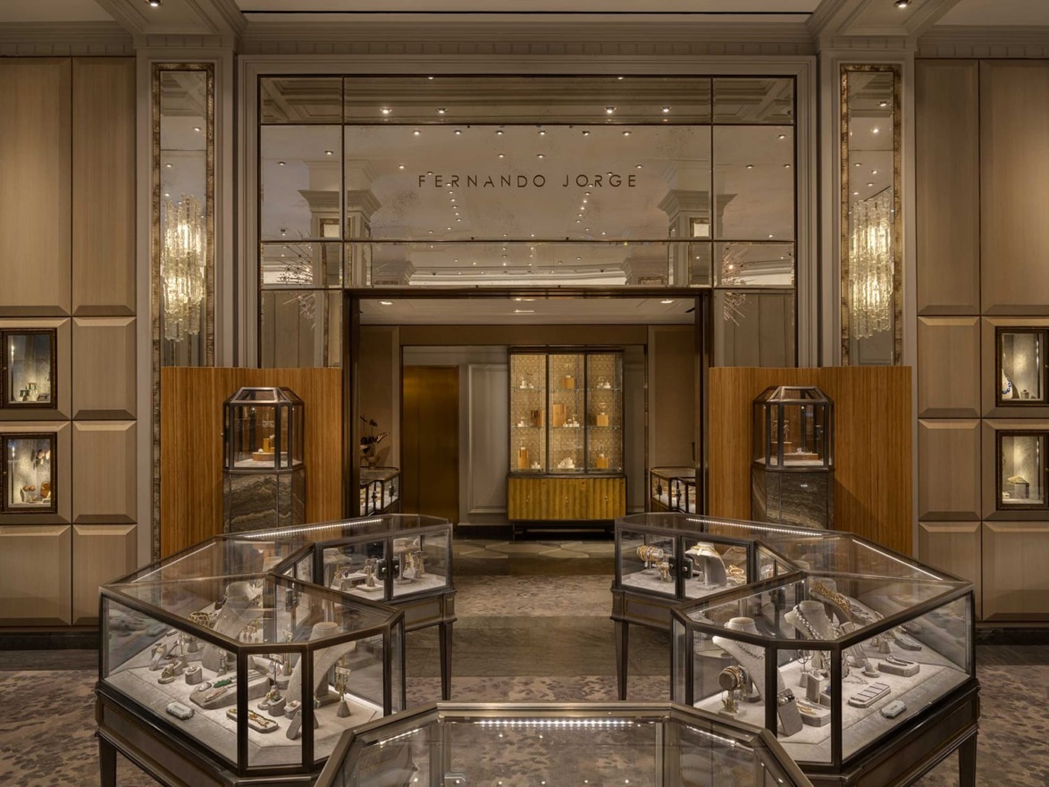 Luxury jewelry store interior with elegant display cases and warm lighting.