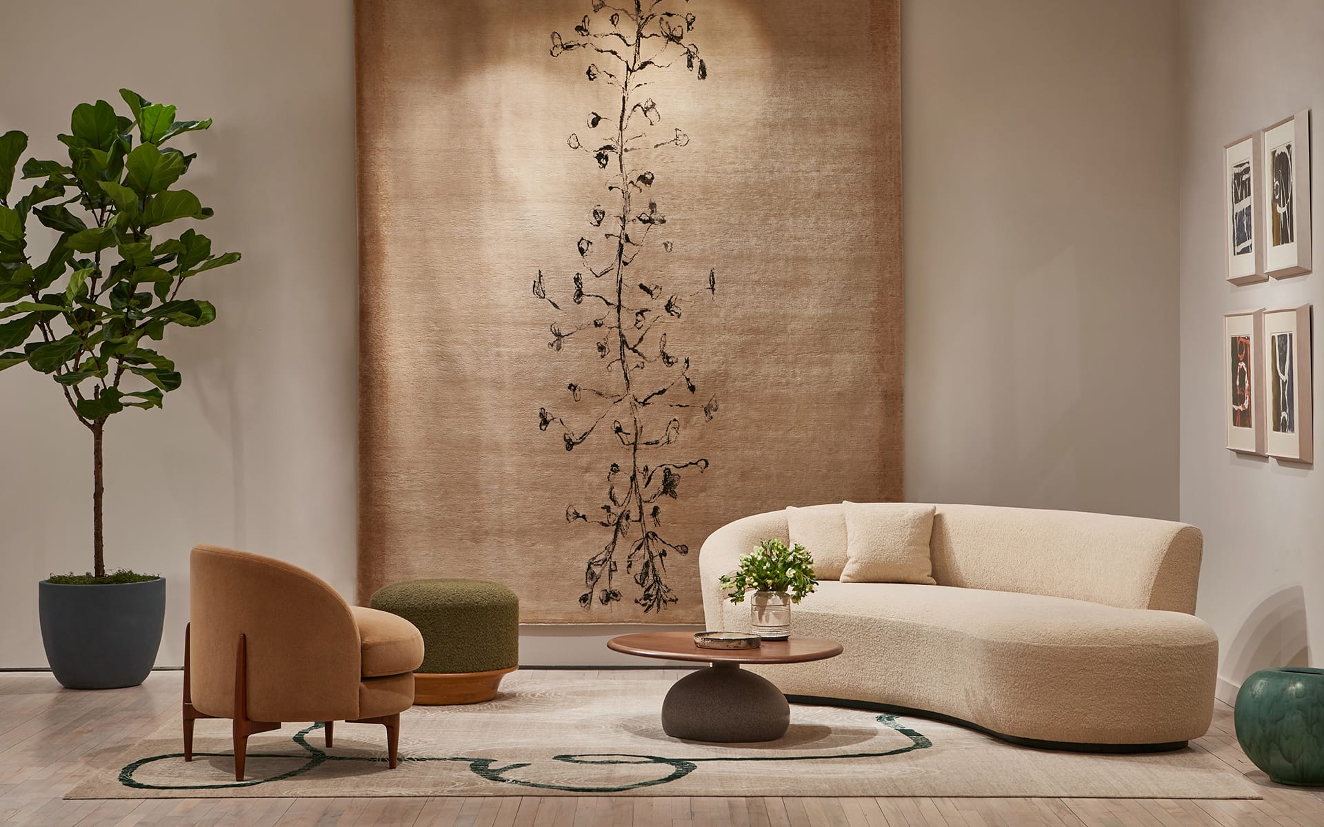 Modern living room with a curved sofa, armchair, round coffee table, potted plant, and wall art rug.