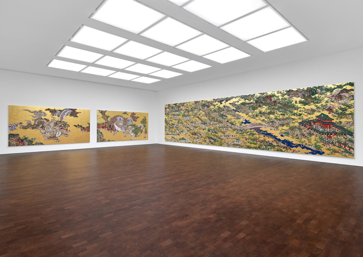 Art gallery with contemporary, colorful paintings on white walls under bright ceiling lights, featuring a wooden floor.