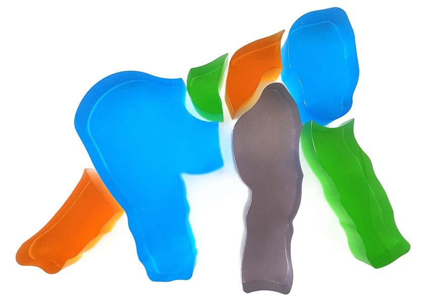 Colorful abstract shapes on a white background, arranged to form an elephant-like figure from various translucent pieces.