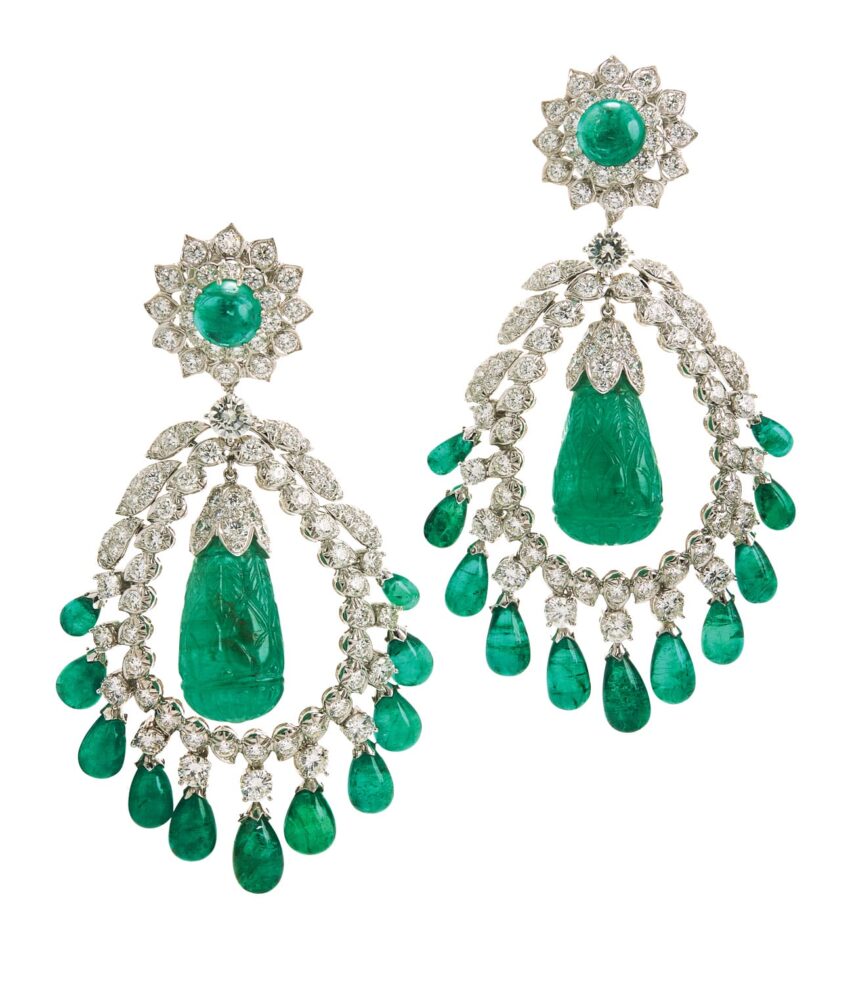 Elegant chandelier earrings with green gemstones and intricate diamond details.
