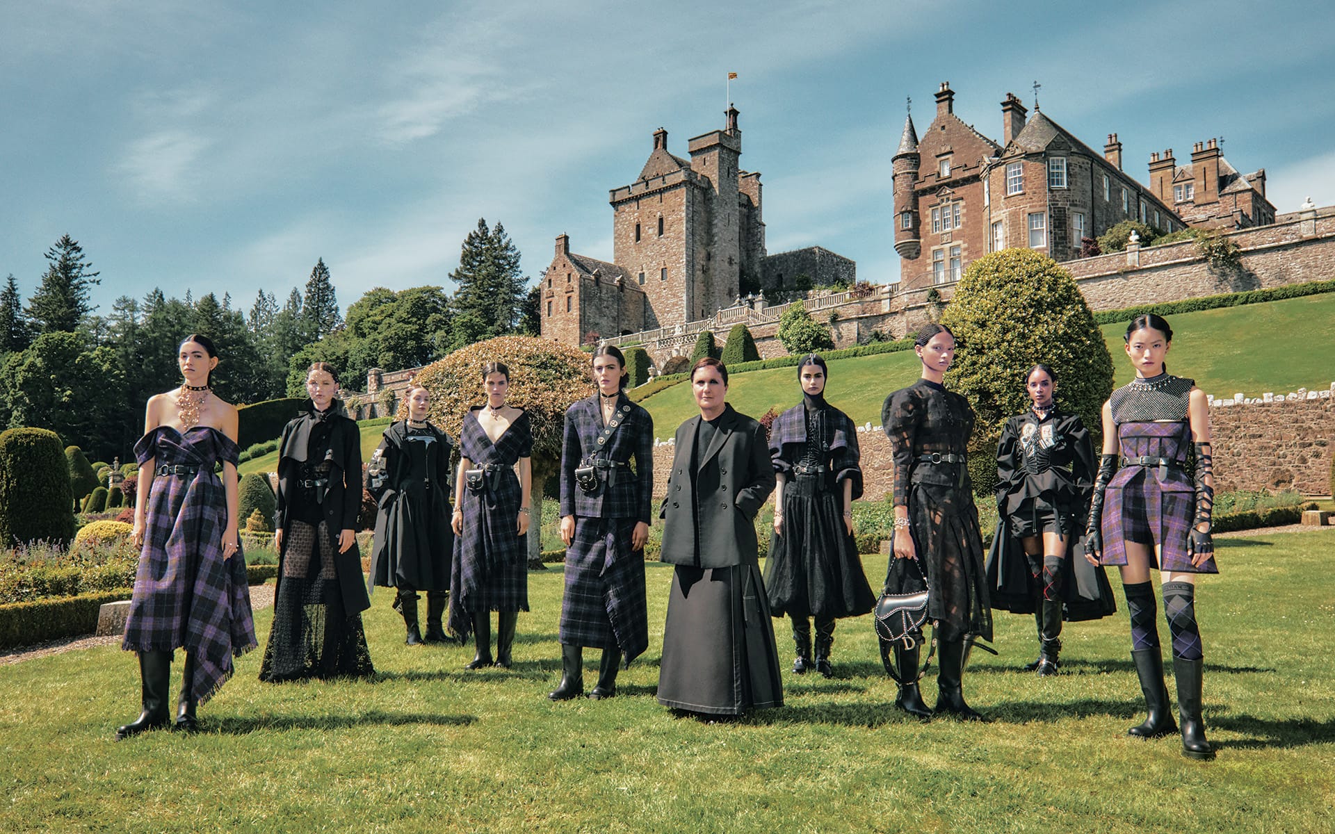 Designer Maria Grazia Chiuri with models wearing looks from the 2025 Cruise collection at Drummond Castle in Perthshire, Scotland.