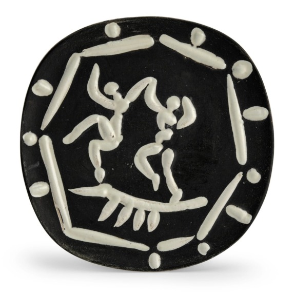 Black ceramic plate with abstract white line drawing of two dancing figures surrounded by geometric shapes.