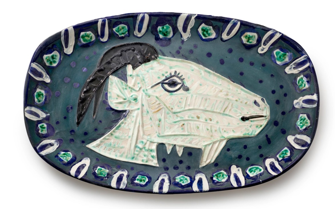 Ceramic plate with abstract goat head design in blue, green, and white tones, featuring intricate details and patterns.