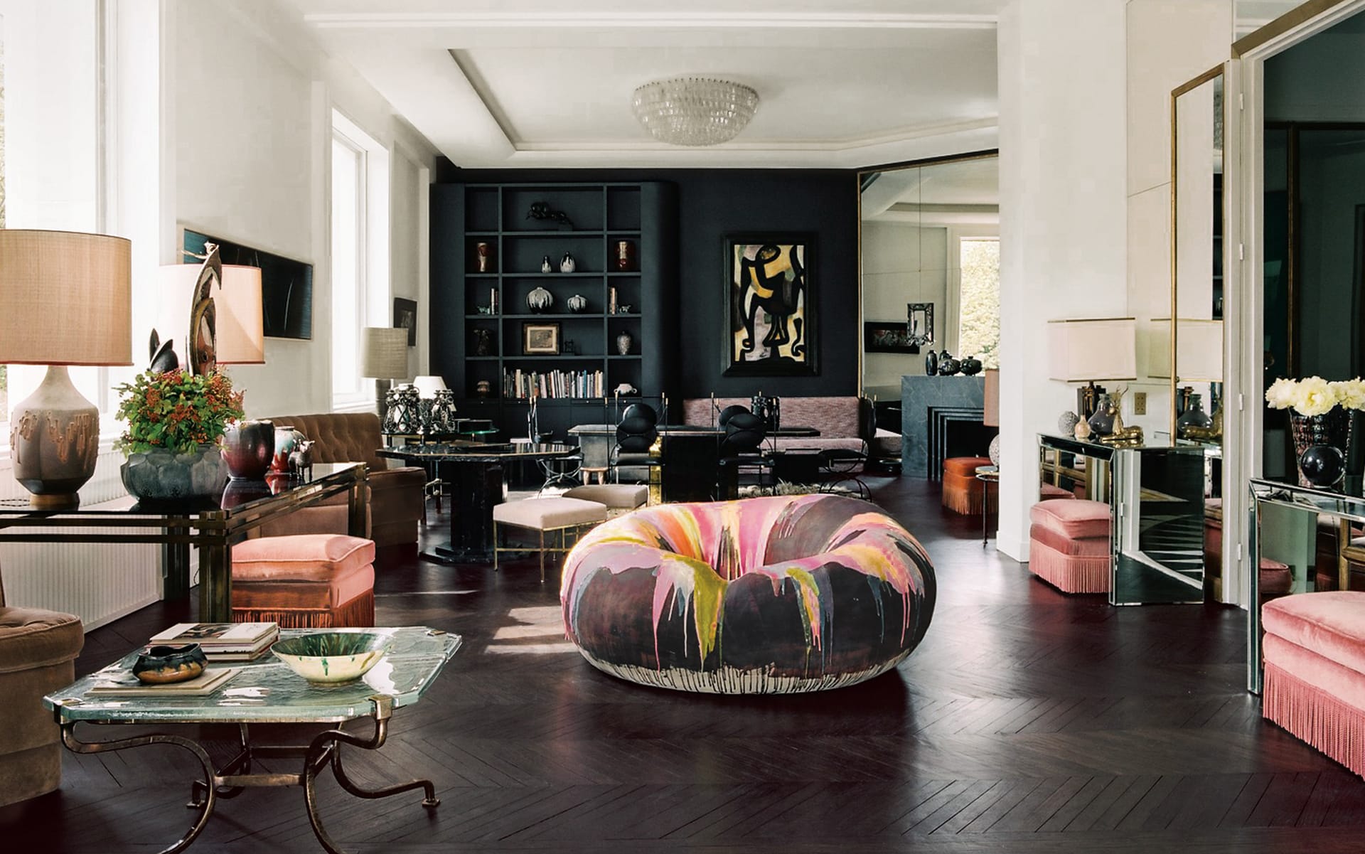 Stylish modern living room with colorful circular sofa, elegant furniture, and decorative accents.
