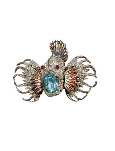 Lionfish-inspired brooch with sparkling gemstones and ornate details featuring multicolored fins and a large central stone.