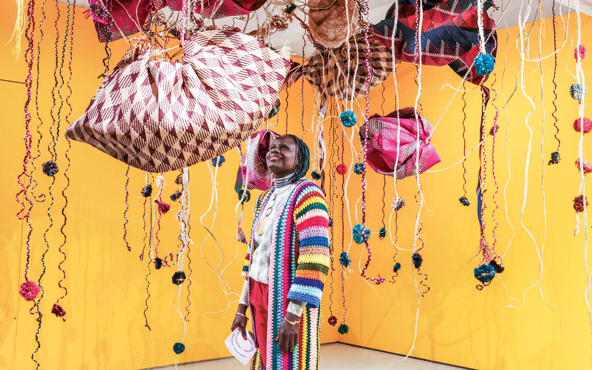 Artist Acaye Kerunen with her work Ayelele (2023) at the Barbican Centre in London.