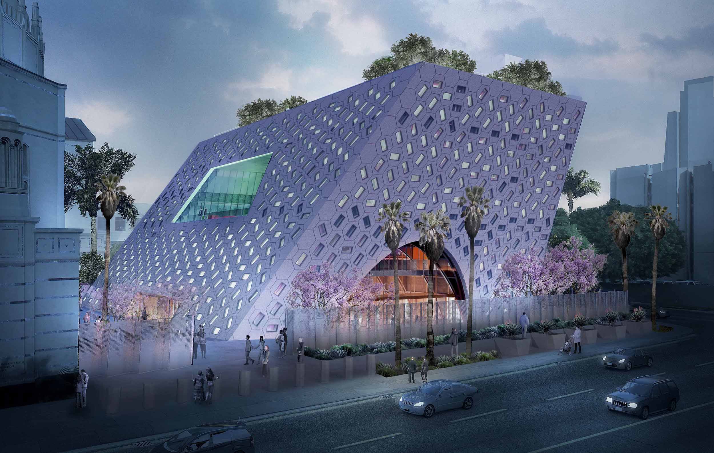 Futuristic angular building with hexagonal patterns, surrounded by trees and people, on a city street.