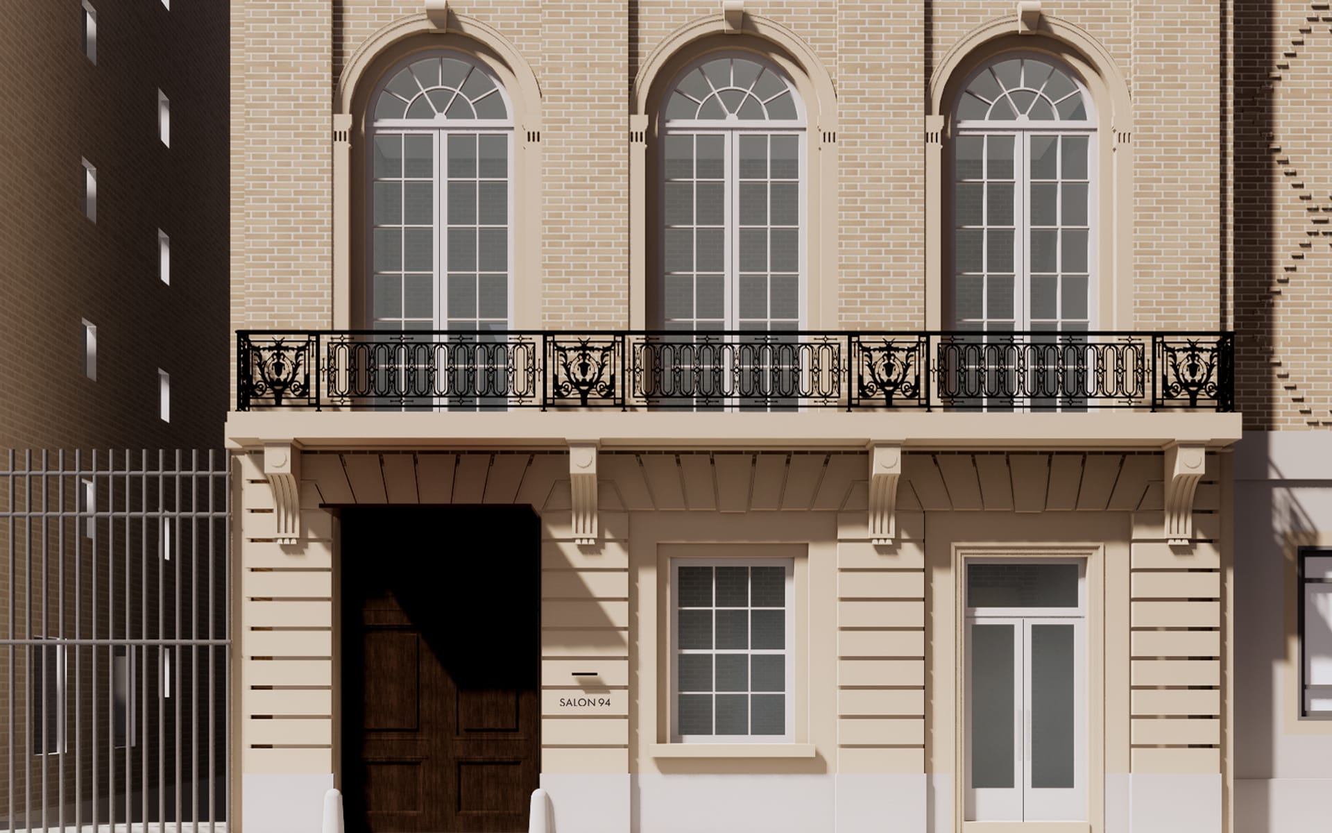 Elegant building facade with arched windows, iron balcony, and light-colored brickwork, located in an urban setting.