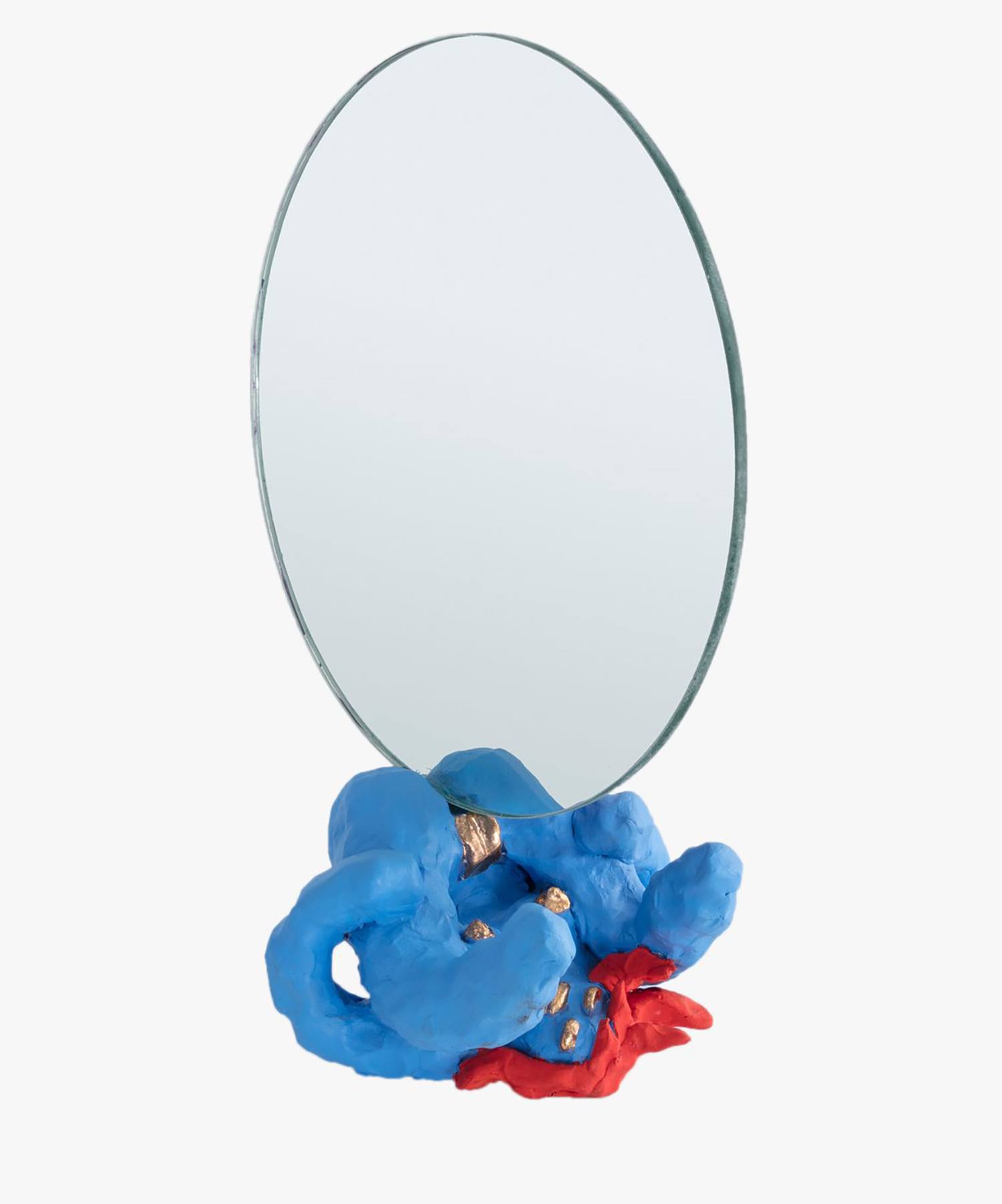 Oval mirror with a blue and red sculptural base featuring abstract shapes and textures.