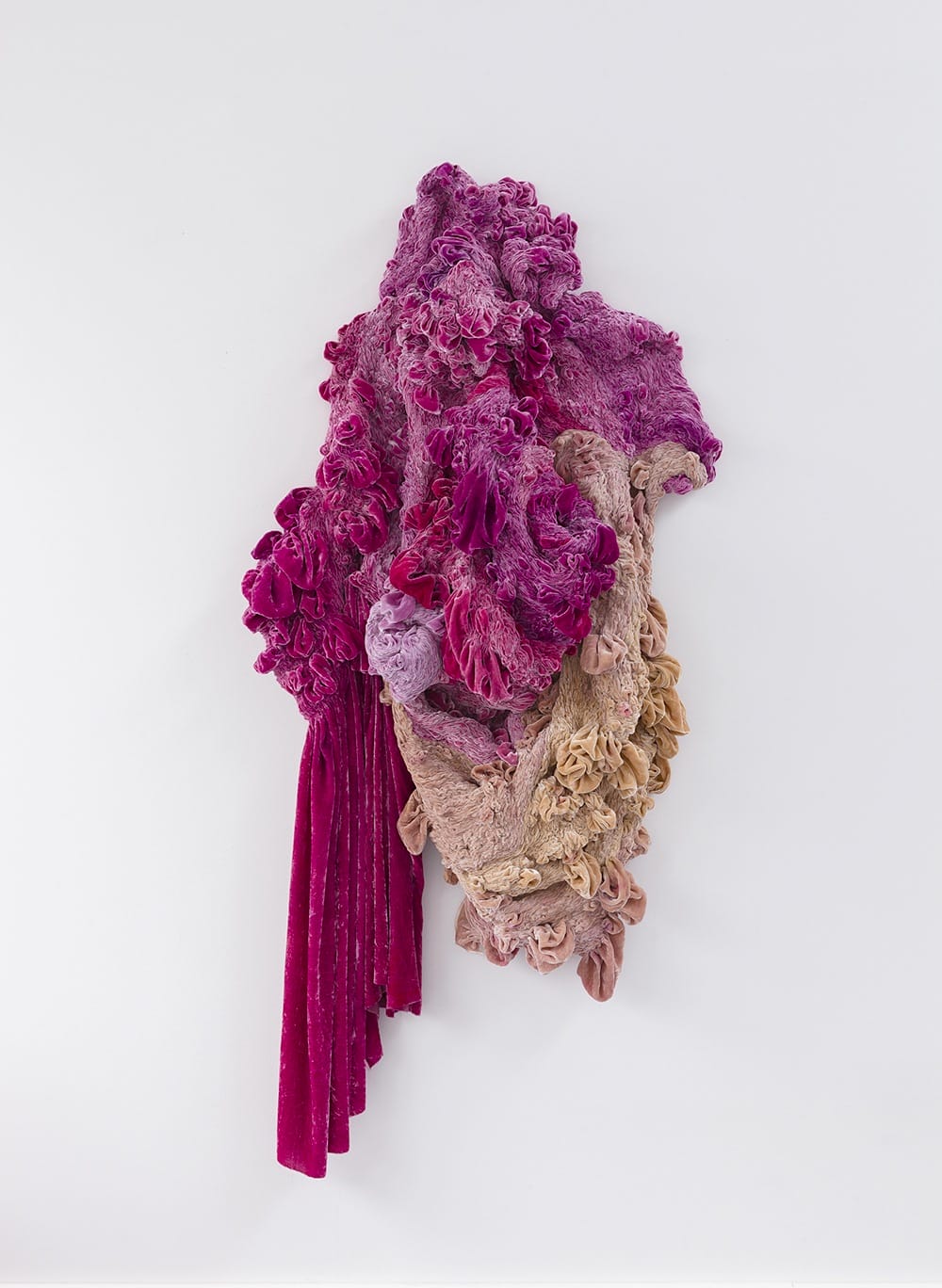 Textured abstract sculpture with vibrant pink and earthy tones against a white background.