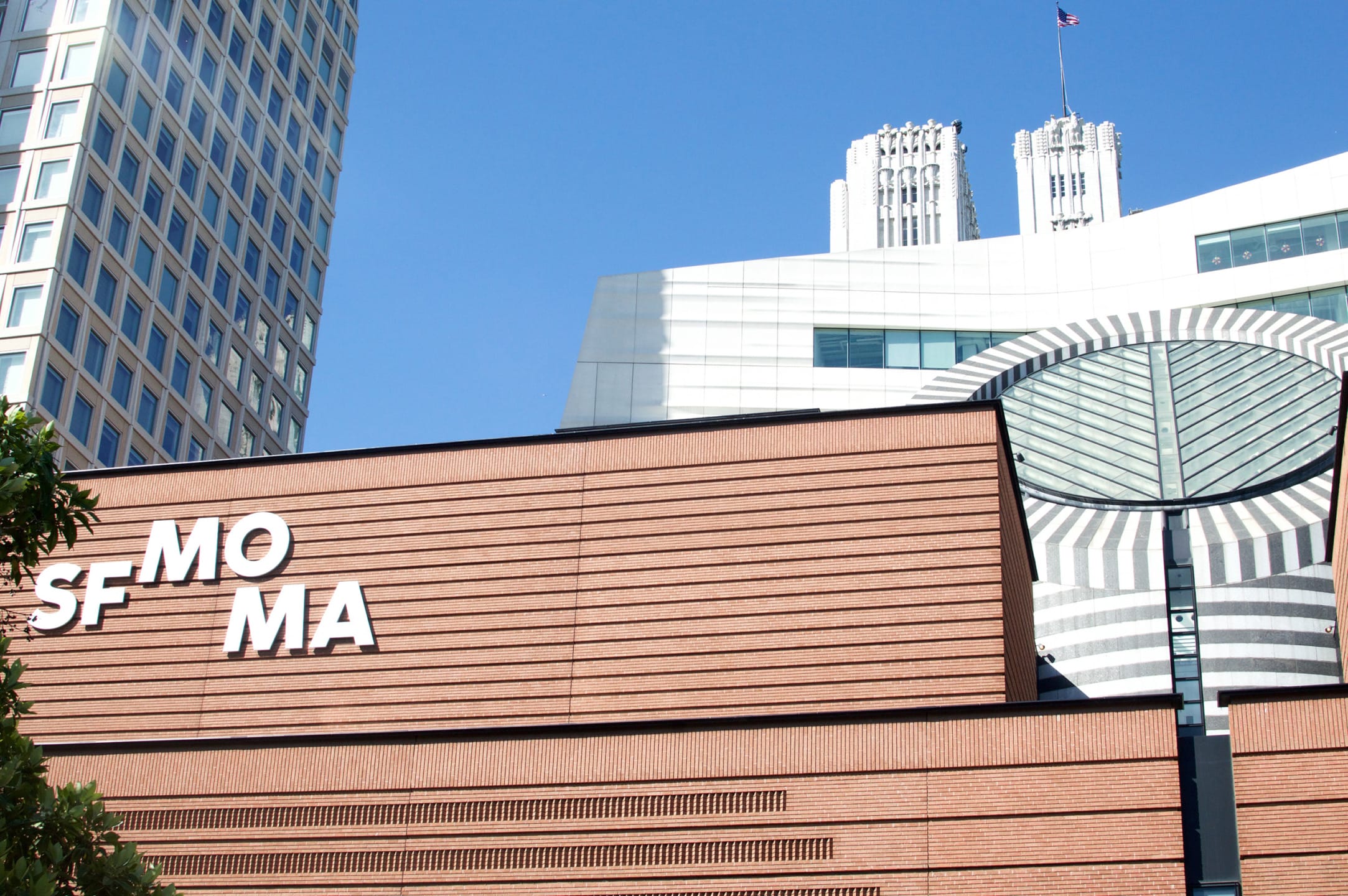 Exterior view of the San Francisco Museum of Modern Art with distinctive architecture under a clear blue sky