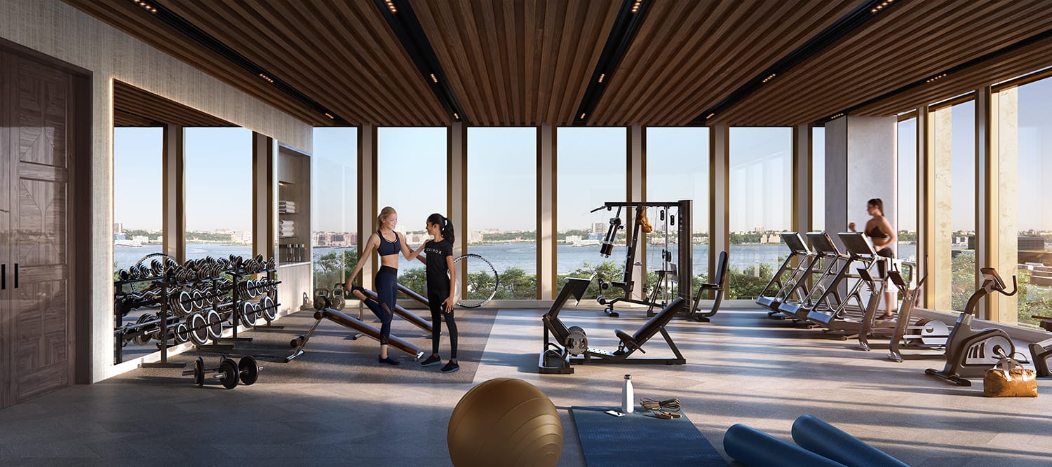 Modern gym with people exercising on cardio and strength equipment, large windows overlooking a scenic waterfront view