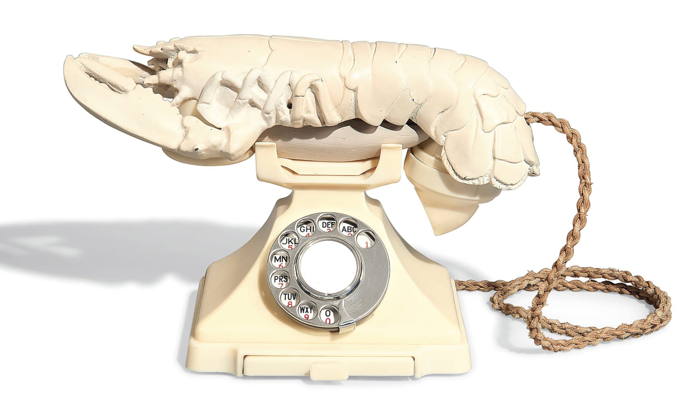Surreal sculpture of a vintage rotary phone with a lobster as the receiver, displaying unique artistic creativity.