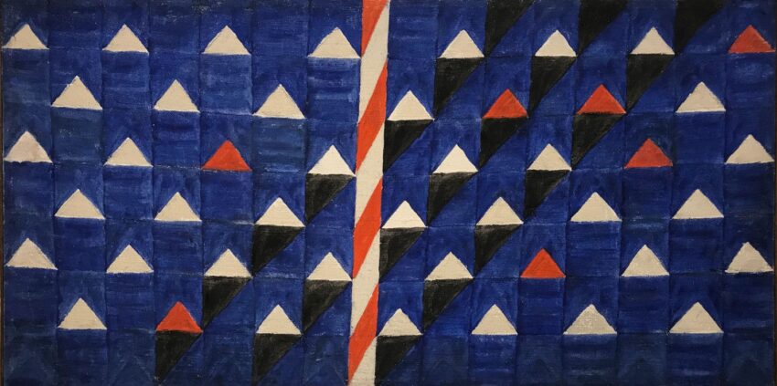 Abstract art featuring geometric triangles in blue, white, black, red with a vertical red and white striped line in the center.