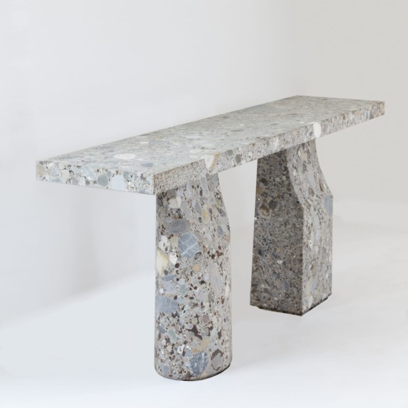 Modern concrete console table with unique speckled texture and two sturdy legs, set against a plain white background.