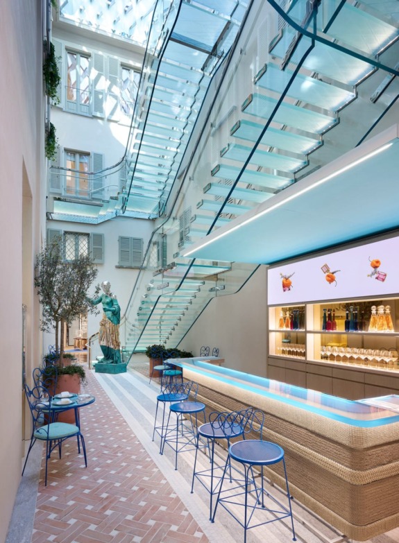 In the interior patio, a sculpture by Daniel Arsham sits underneath a frosted glass staircase.