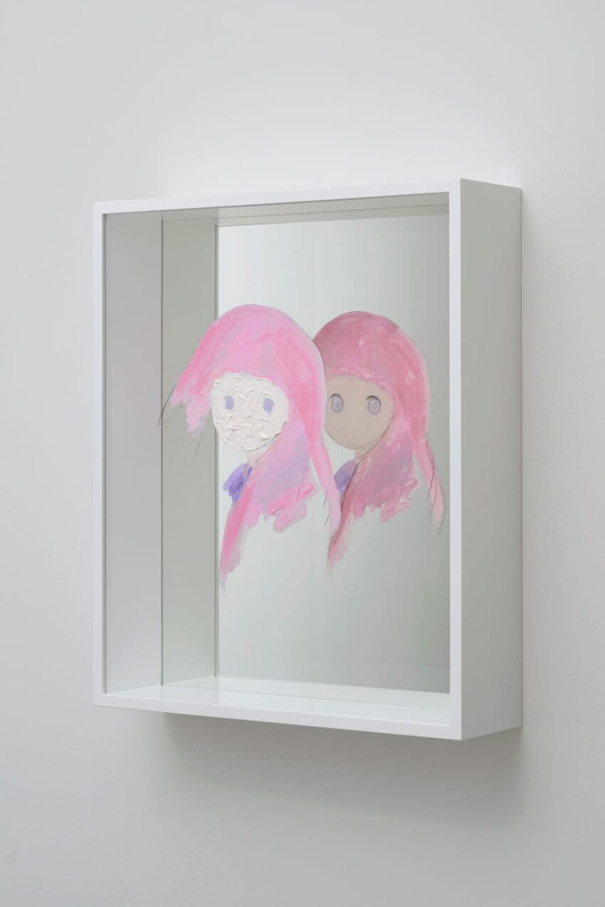 Artwork featuring two stylized figures with pink hair painted on a mirrored surface in a white frame.