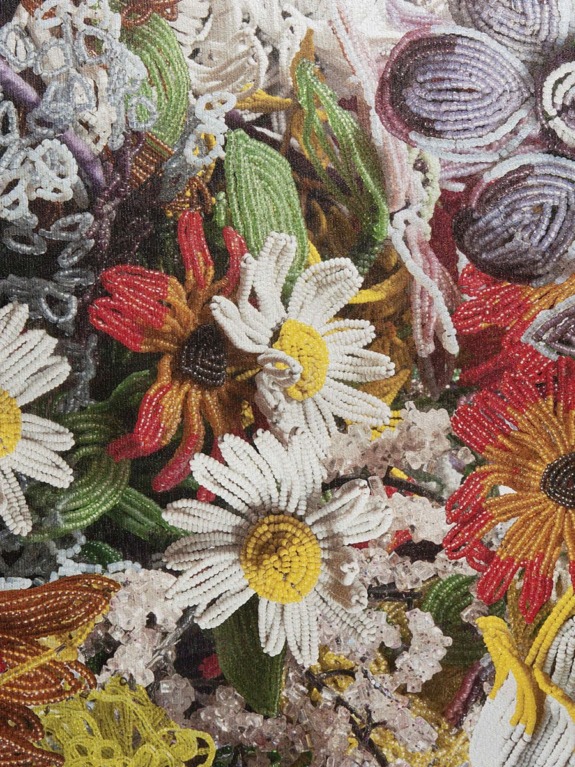 Colorful beaded flowers with intricate designs, showcasing daisies and a variety of other floral patterns.