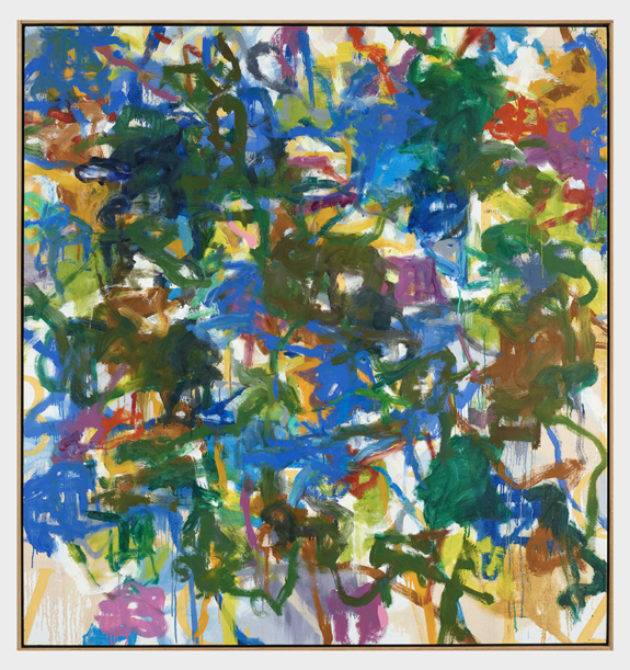 Abstract painting with vibrant splashes of blue, green, yellow, and red on canvas, creating a dynamic and chaotic visual.