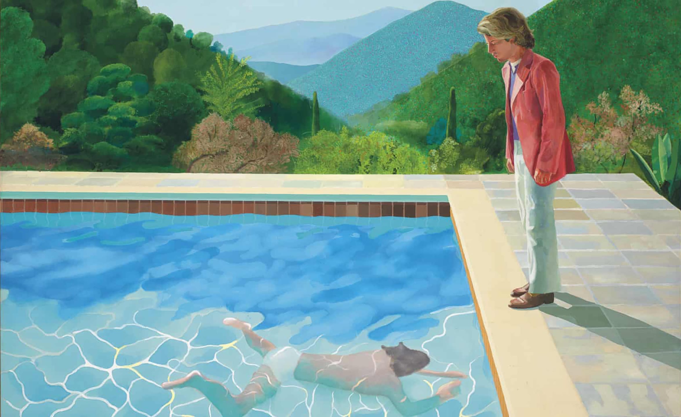 A person watching another swim in a clear blue pool surrounded by lush green hills and mountains in the background.