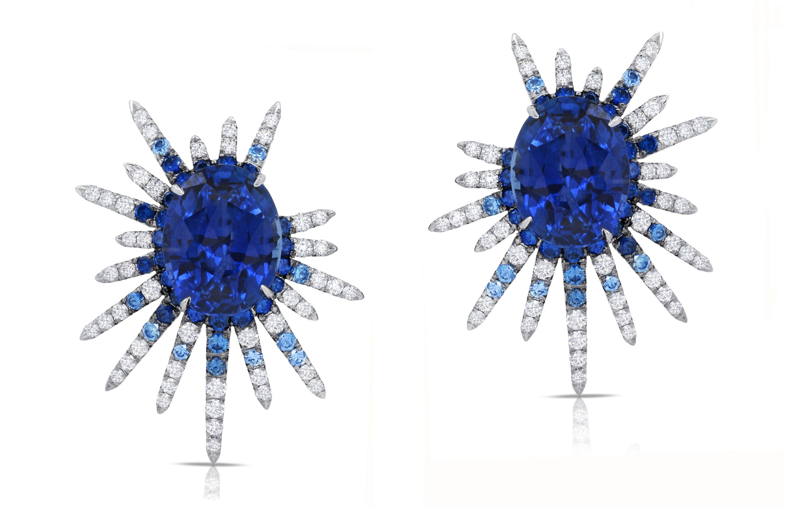 Blue sapphire and diamond starburst earrings with intricate design.