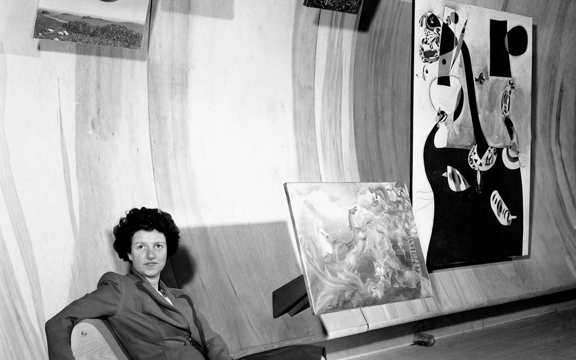 Peggy Guggenheim at her gallery with works from "Exhibition by 31 Women," which showcased surrealism.