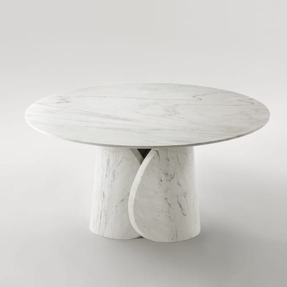 Round marble table with a modern design featuring a cylindrical base on a neutral background.