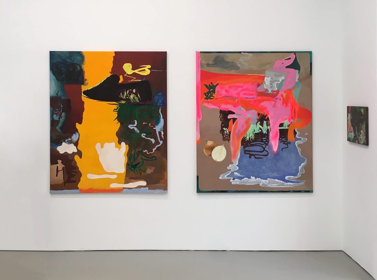 Abstract paintings with vibrant colors hung on a white gallery wall.