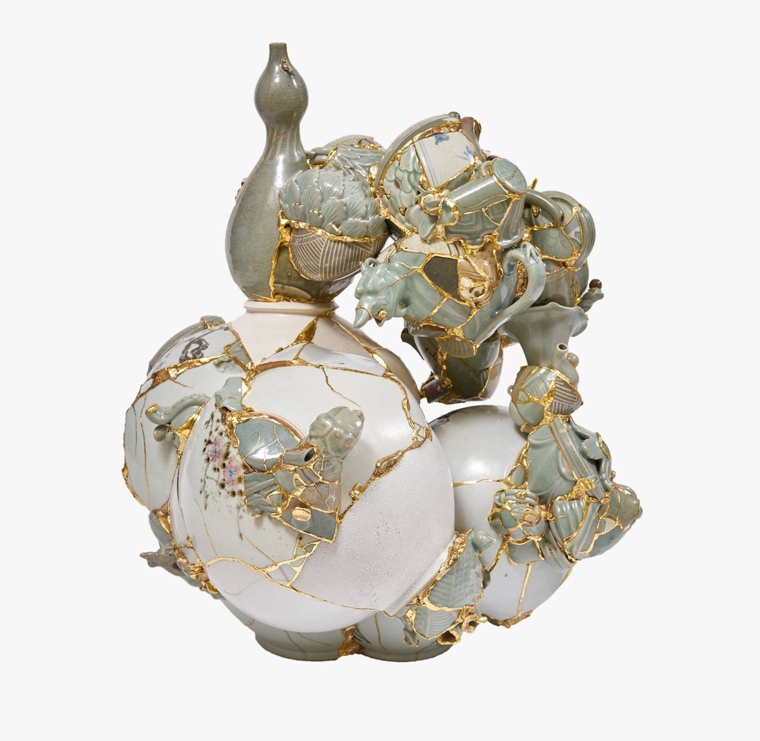 Ceramic sculpture with intricate gold repair, showcasing traditional kintsugi technique on broken porcelain pieces.