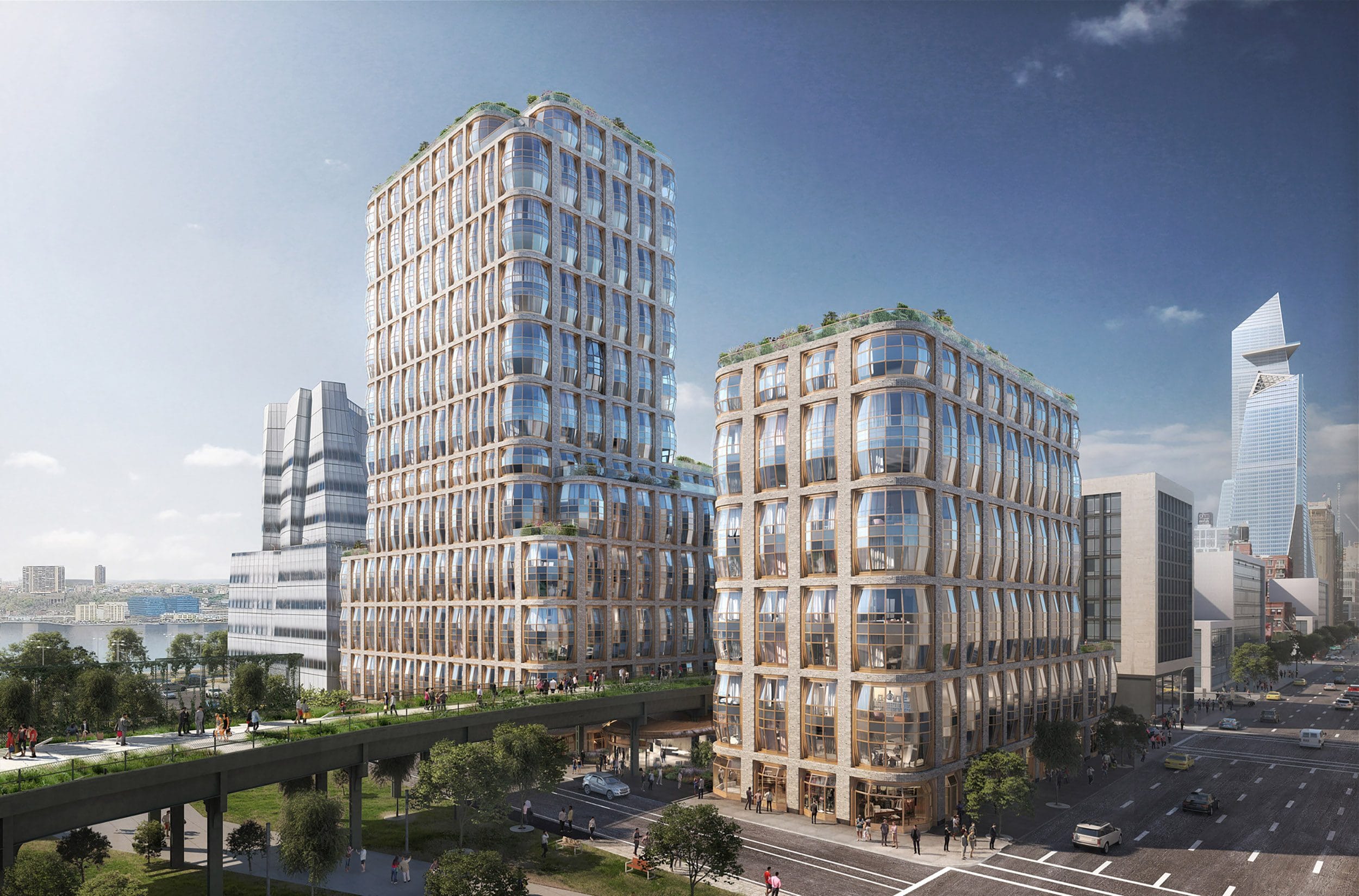 Modern urban buildings with glass facades under a blue sky, surrounded by greenery and a city street in the foreground.