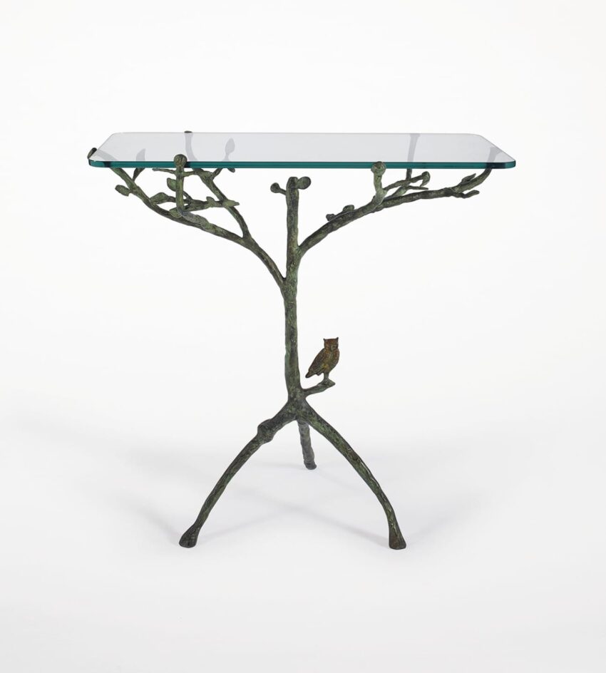 Glass top side table with a bronze branch-like base and a small owl detail.