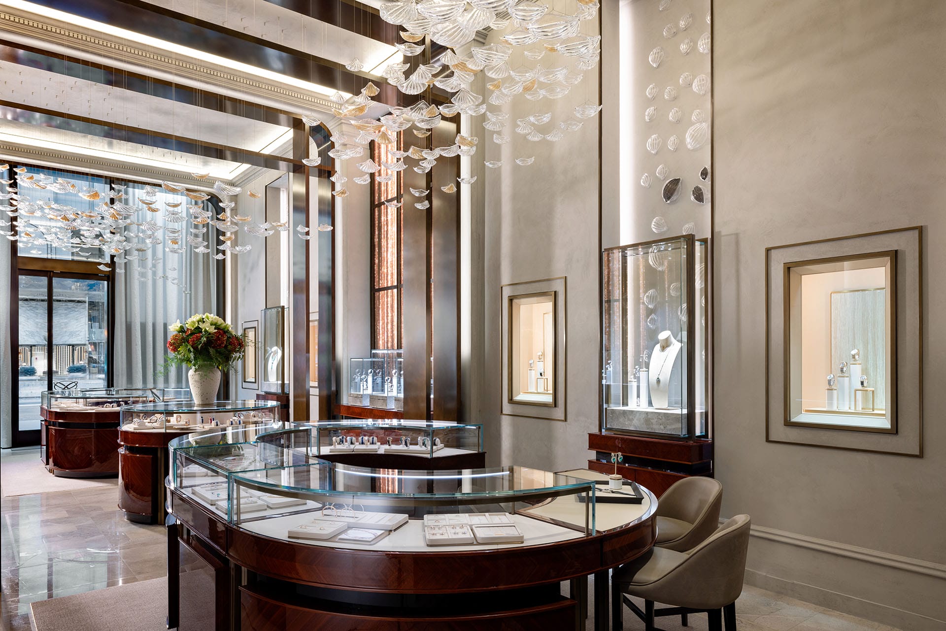 Luxury jewelry store interior with elegant displays, glass cases, and decorative ceiling elements.