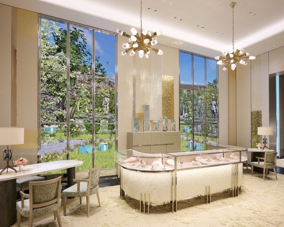 Digital displays backdrop a jewelry gallery.