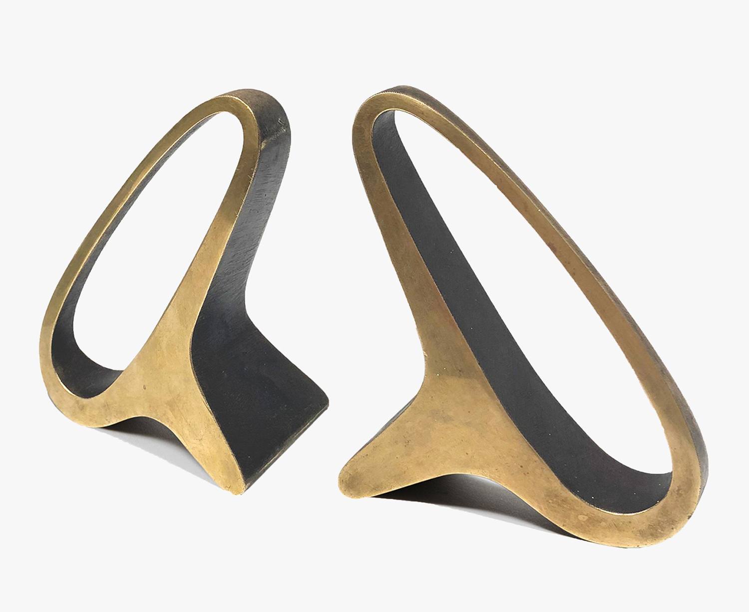 Two abstract bronze sculptures with curved, open shapes on a white background.