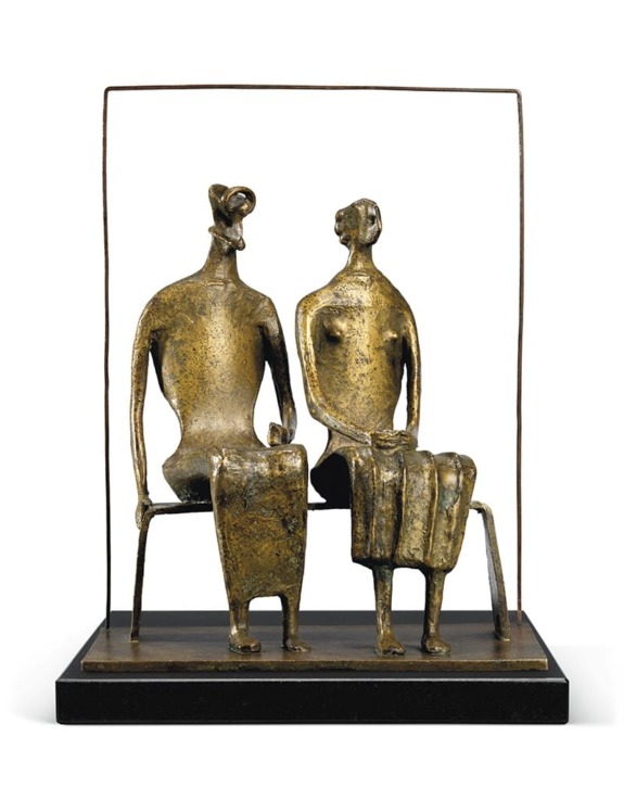 Bronze sculpture of two abstract figures seated, looking at each other, mounted on a rectangular black base.