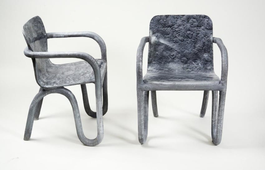 Two modern, textured chairs made of moon surface-inspired material, showcasing unique curved and angular designs.