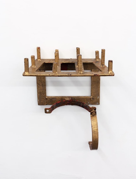 Rustic metal wall-mounted sculpture with rectangular grid and curved bottom piece against a white background.