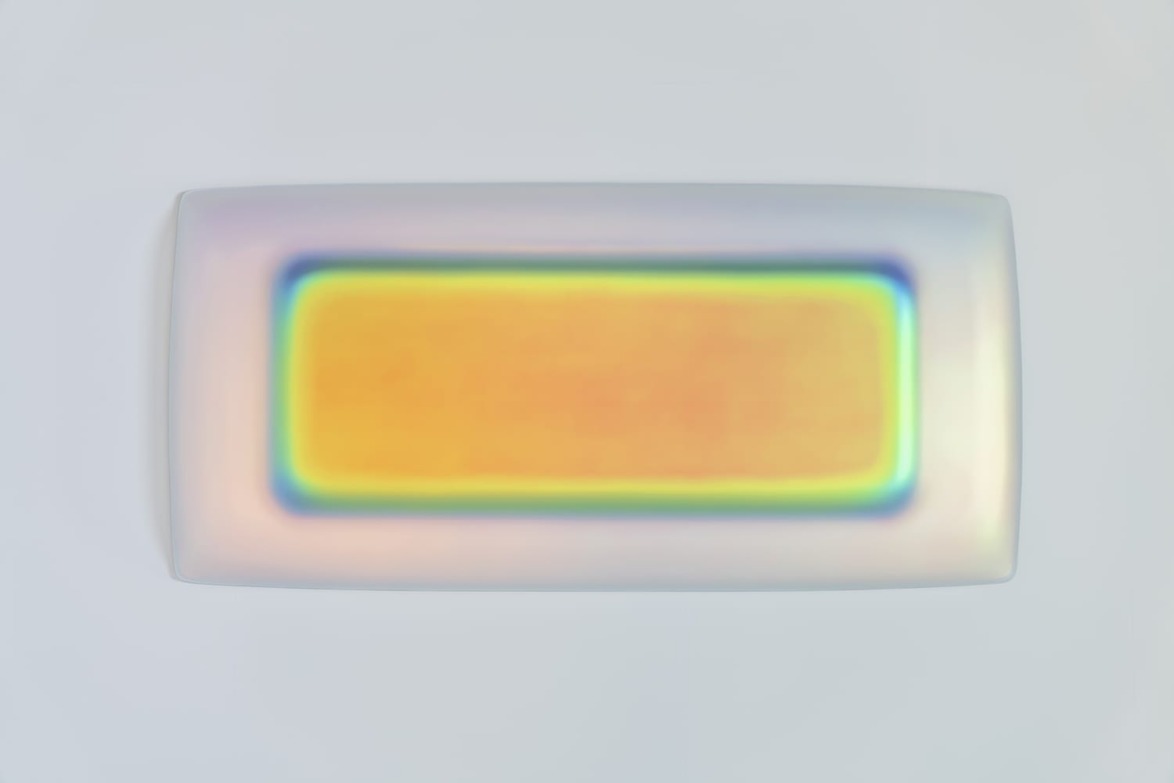 Colorful abstract art with a rectangular shape in warm hues, surrounded by a gradient of soft blues and greens.