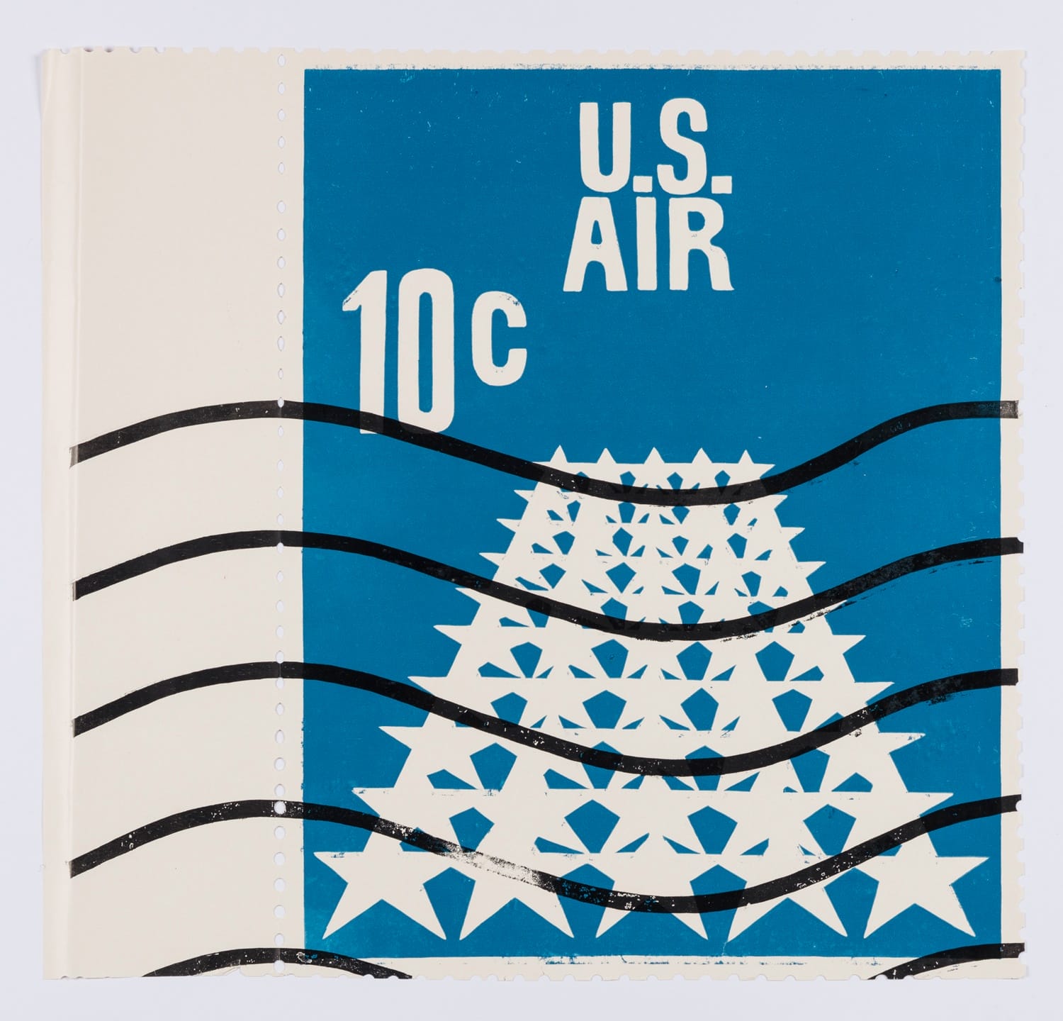 U.S. Air 10-cent stamp featuring a design of white stars arranged in a pyramid shape on a blue background.