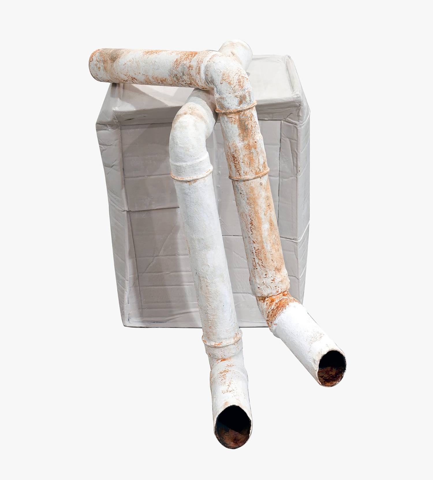 Rusty white metal pipes intersecting against a plain background, placed on a square block.