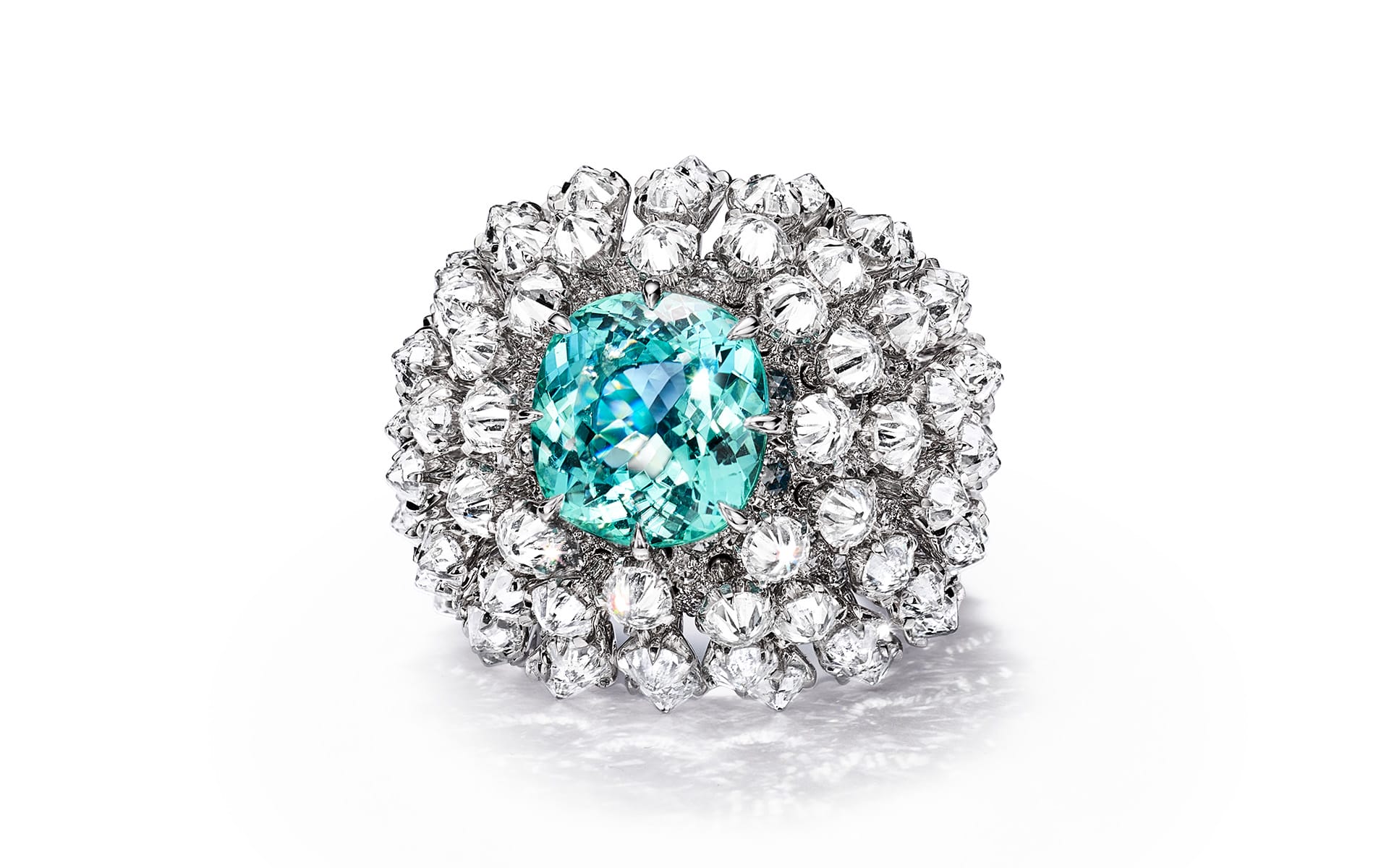 Luxurious ring featuring a central blue gemstone surrounded by sparkling diamonds set in an intricate design.