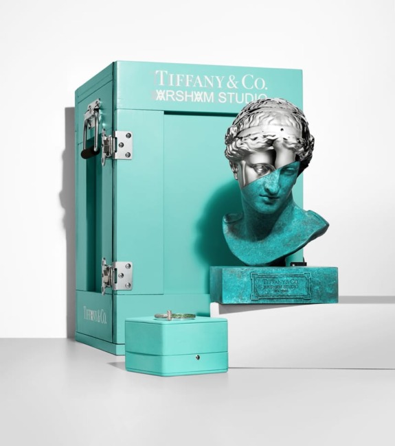 Tiffany & Co. box with intricate sculpture, turquoise gift box, and luxury bracelet on display.