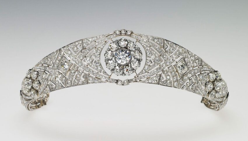 Exquisite diamond tiara with intricate design and central floral motif displayed on a neutral background.