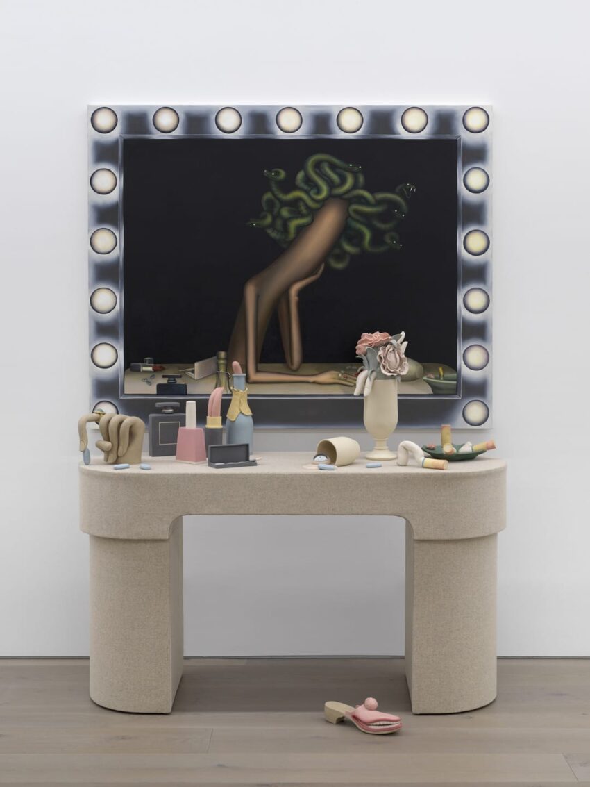 Surreal artwork with a mirror surrounded by lights, abstract figure, and eclectic objects on a beige vanity table.