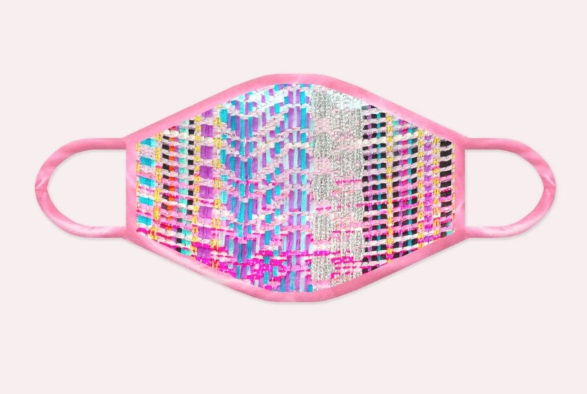 Colorful patterned face mask with pink edges on a white background.