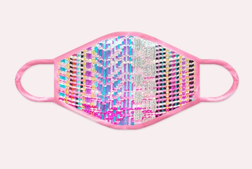 Colorful patterned face mask with pink edges on a white background.