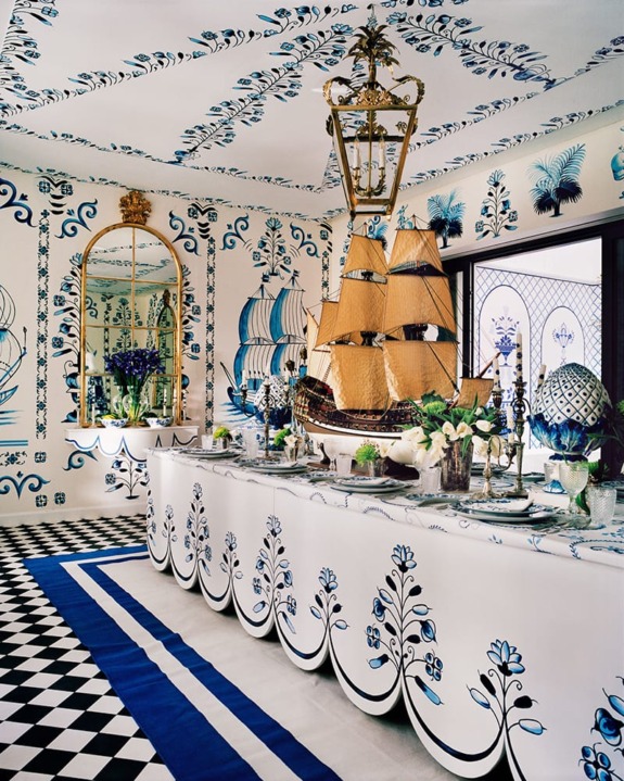 Elegant dining room with nautical-themed decor, featuring a large ship centerpiece, blue patterns, and checkered floor.